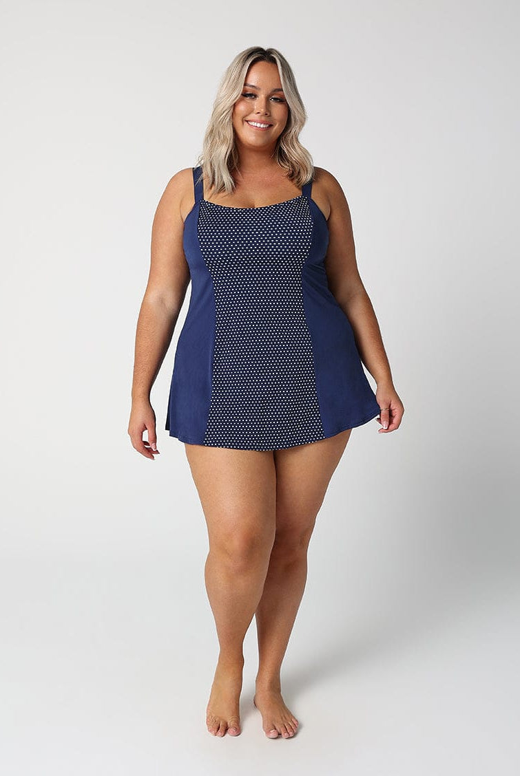 Woman wearing a blue patterned dress on a white background