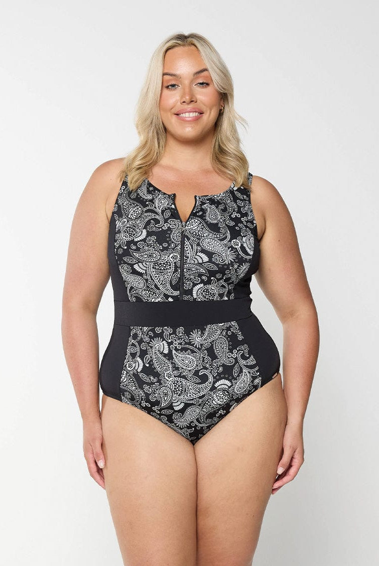 Blonde women in studio wearing plus size one piece with half zip detail in chlorine resistant fabric