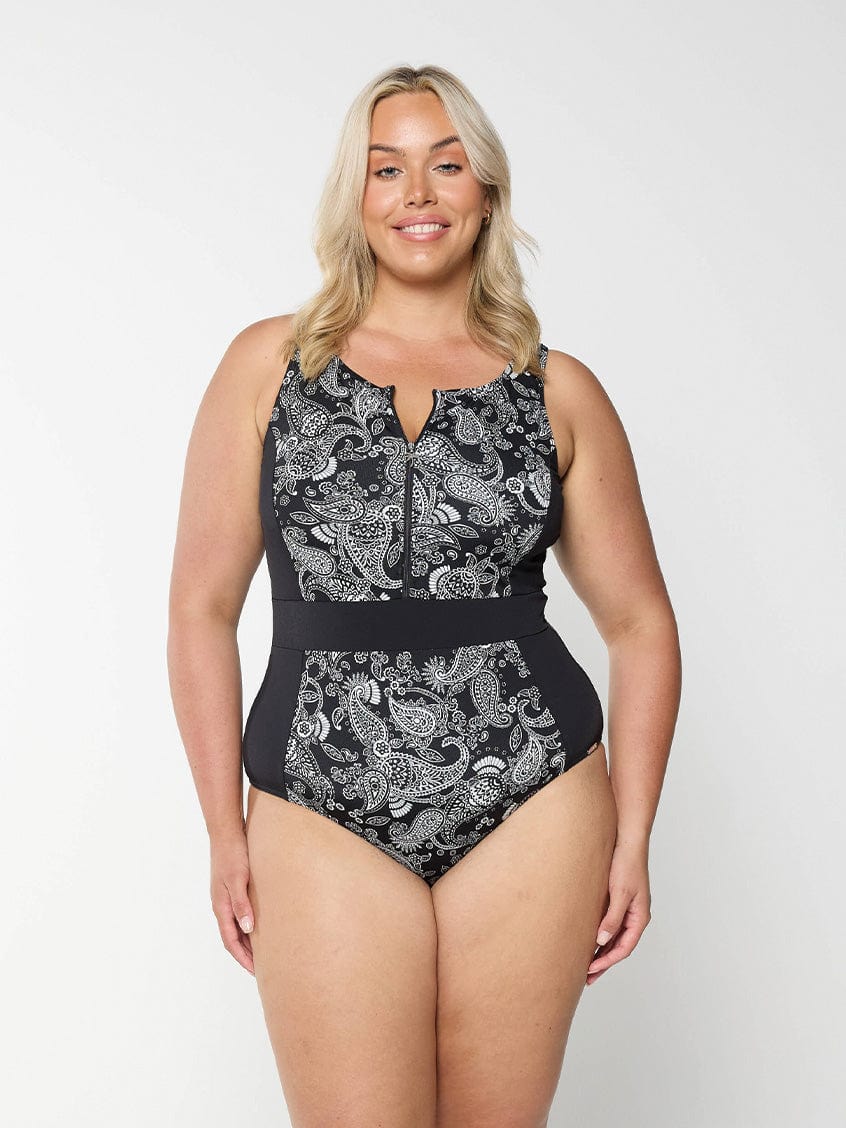 Blonde women in studio wearing plus size one piece with half zip detail in chlorine resistant fabric