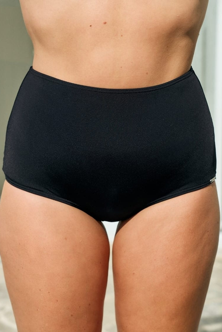 Model wearing a black high waisted pant in chlorine resistant