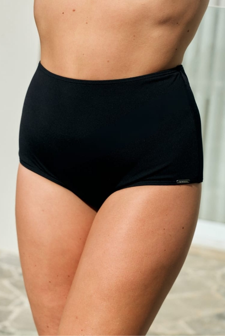 Side profile of model wearing a black high waisted pant for curve women in chlorine resistant