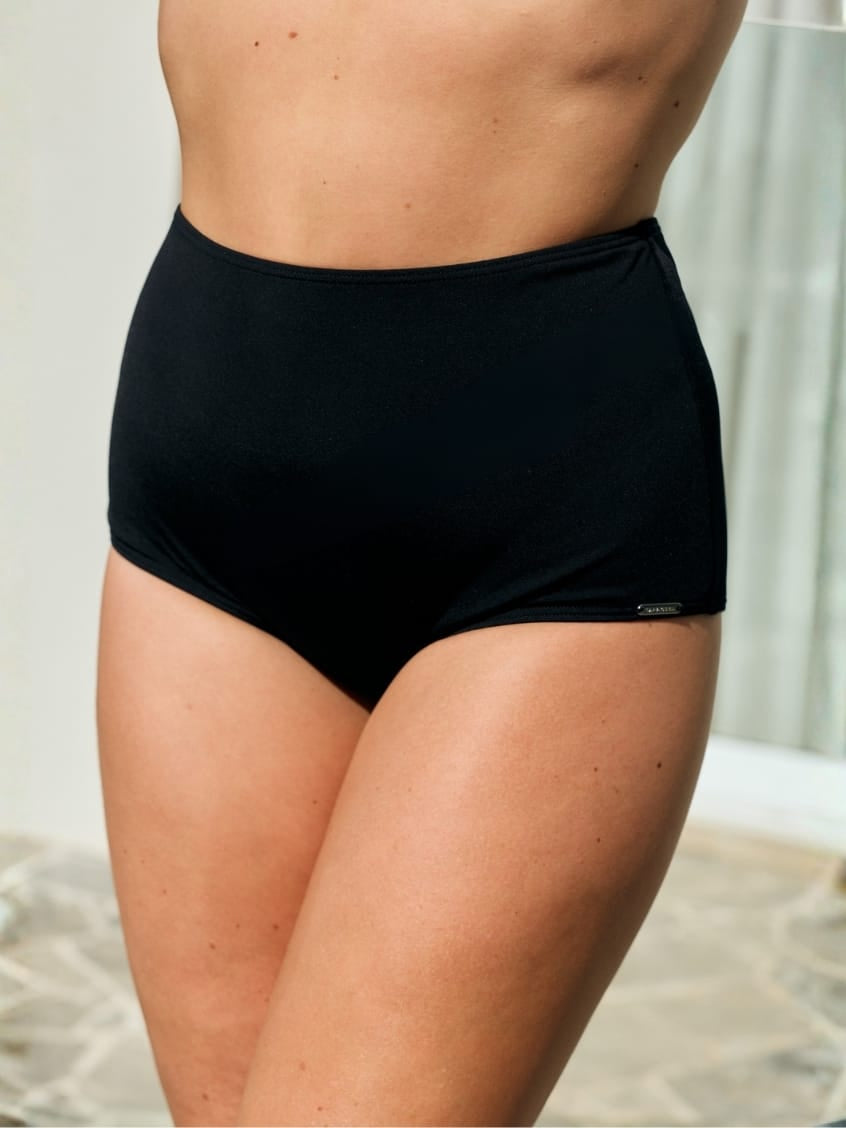 Side profile of model wearing a black high waisted pant for curve women in chlorine resistant