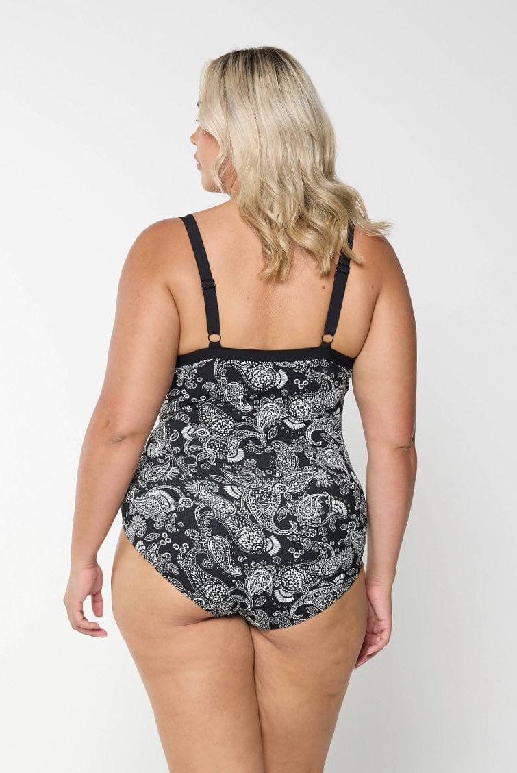 Back of model wearing a plus size tankini top with underwire support in a paisley print with adjustable straps.