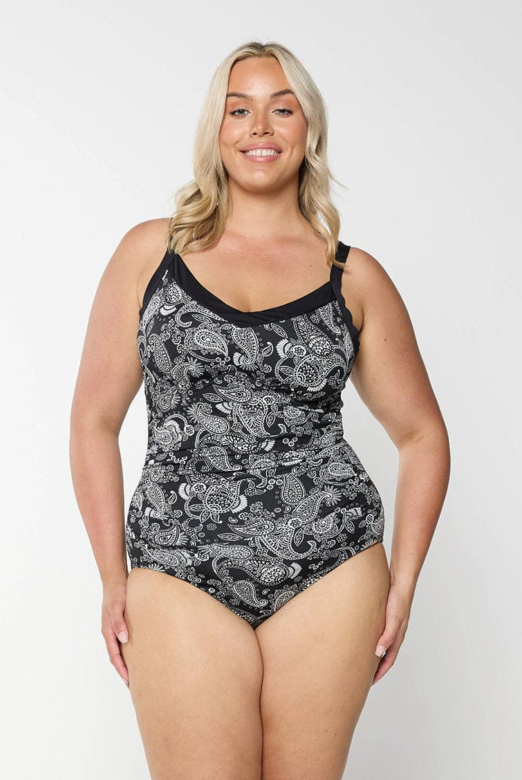 Blonde woman wearing plus size underwire tankini top with black and white paisley print