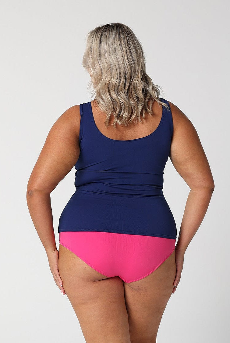 Back of model in studio showing off navy and pink chlorine resistant zip front tankini