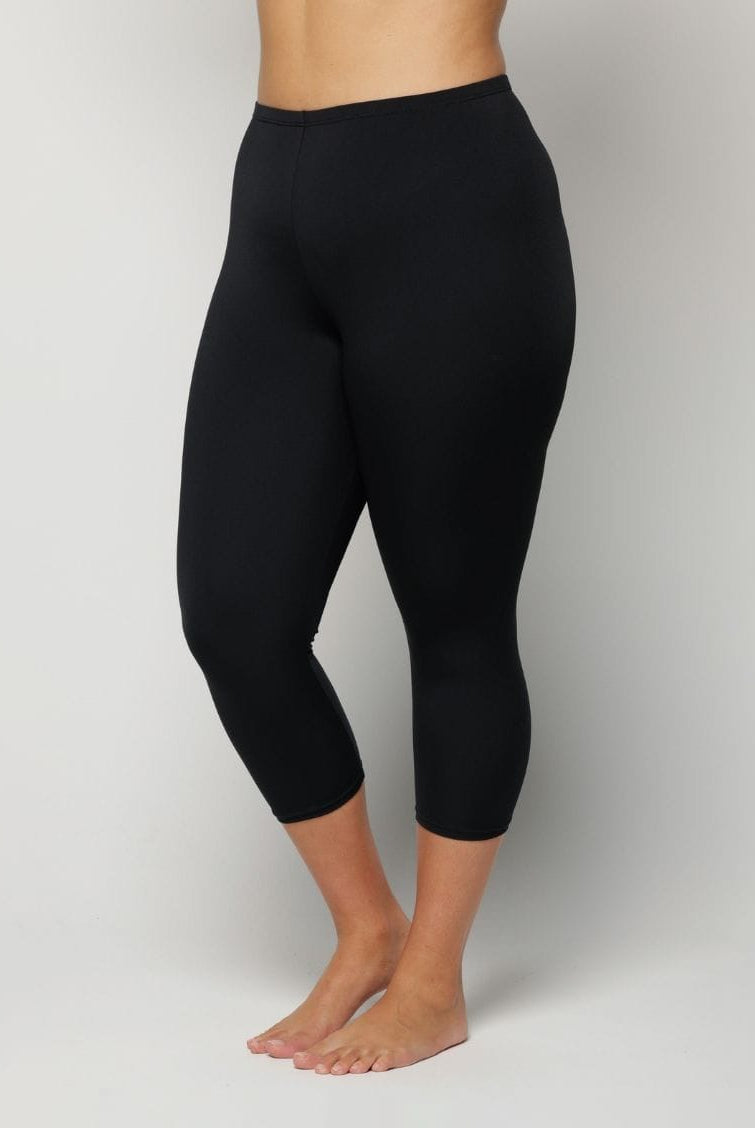 Black leggings worn by a Woman on a plain background
