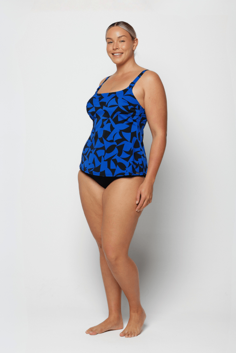 Woman wearing a blue patterned swimsuit on a white background