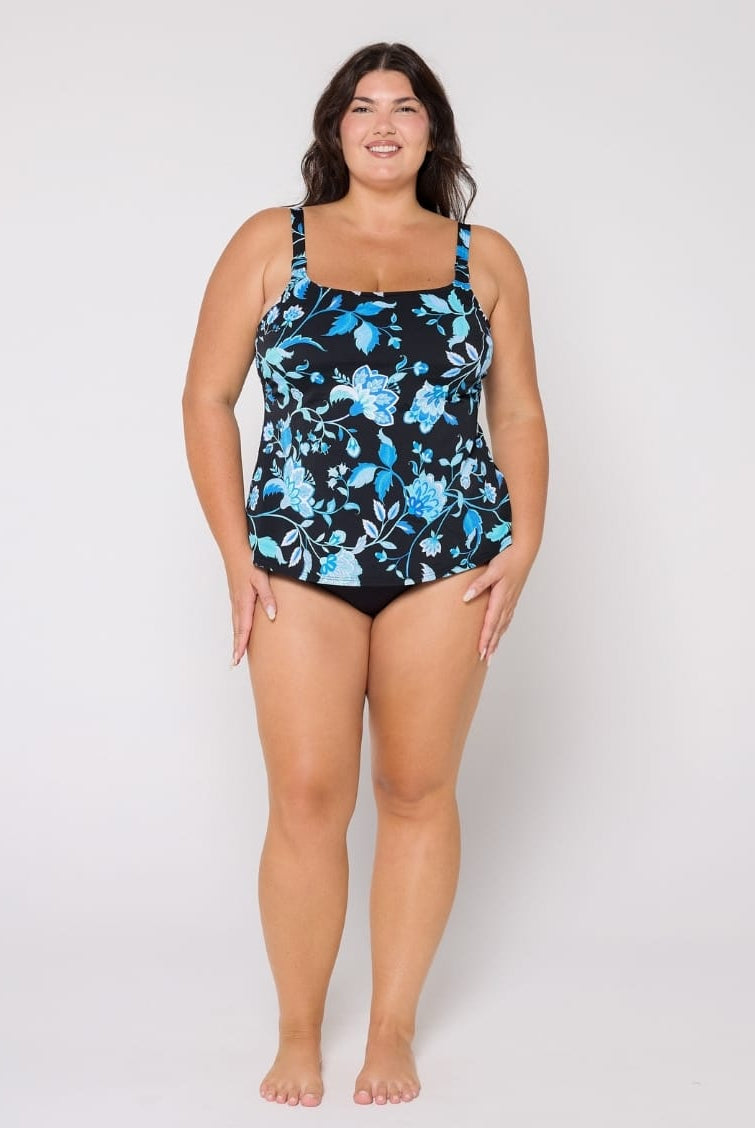 Woman wearing a floral-patterned tankini on a white background
