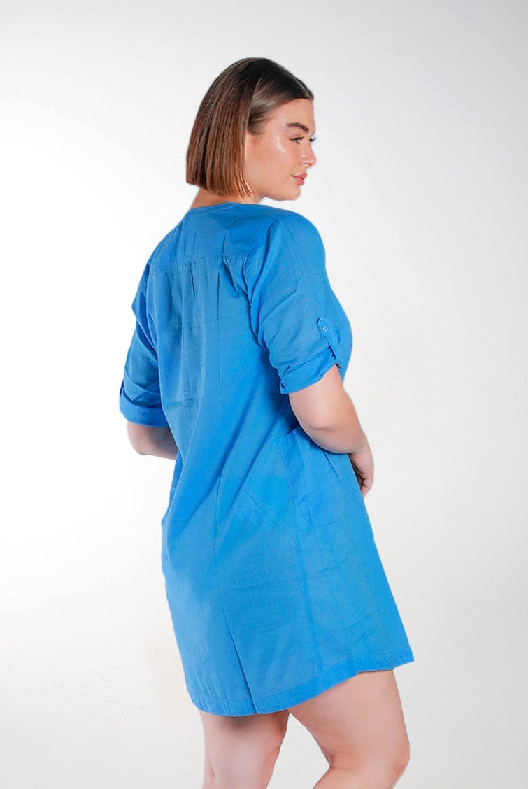 brunette model wearing blue plus size over shirt with roll up sleeves