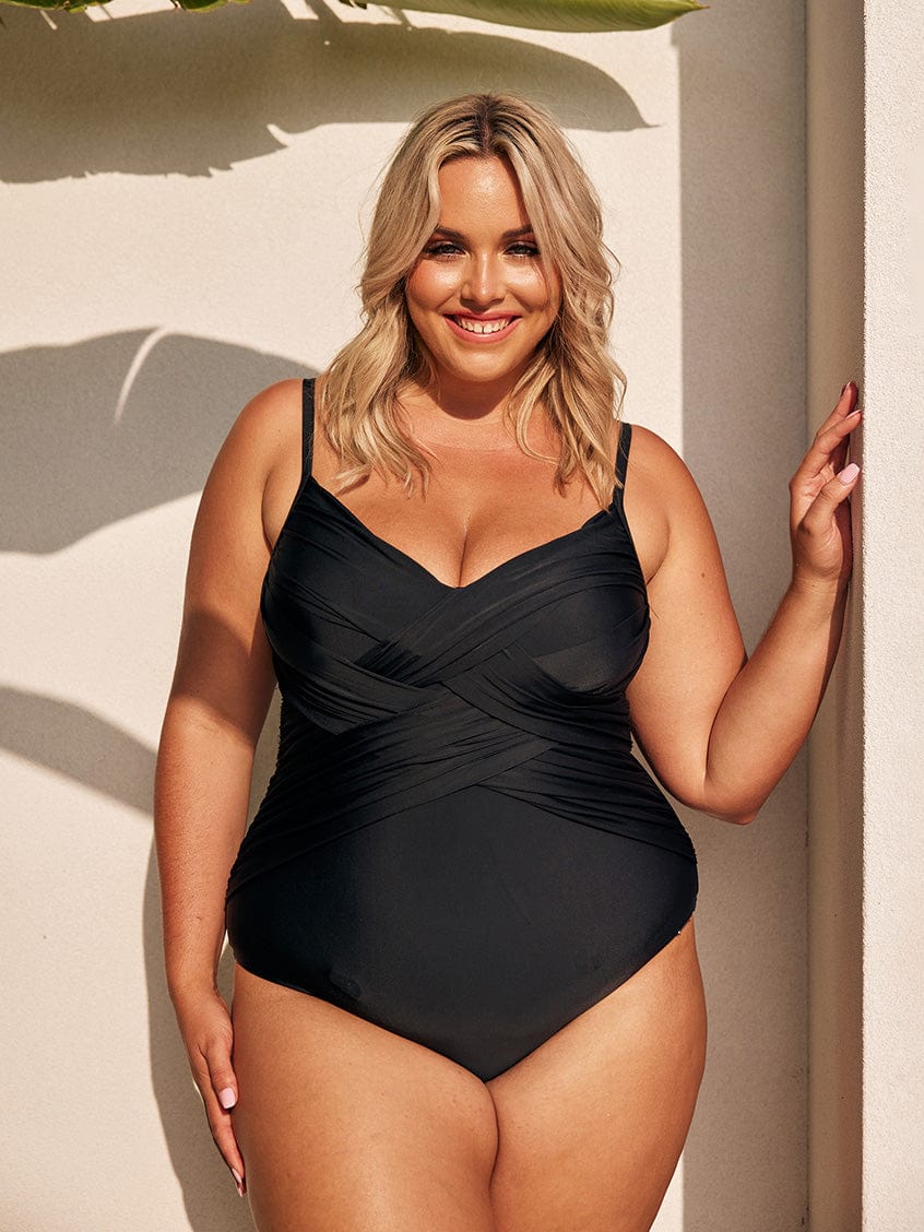 Blonde model wearing black criss cross one piece
