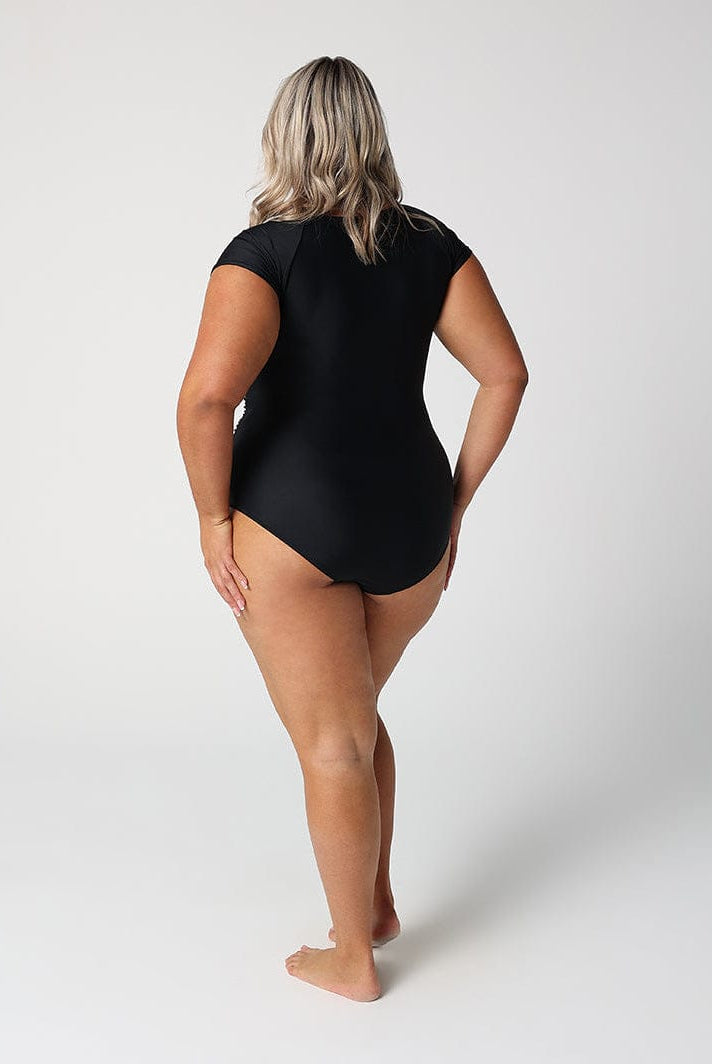 Person wearing a black swimsuit on a white background