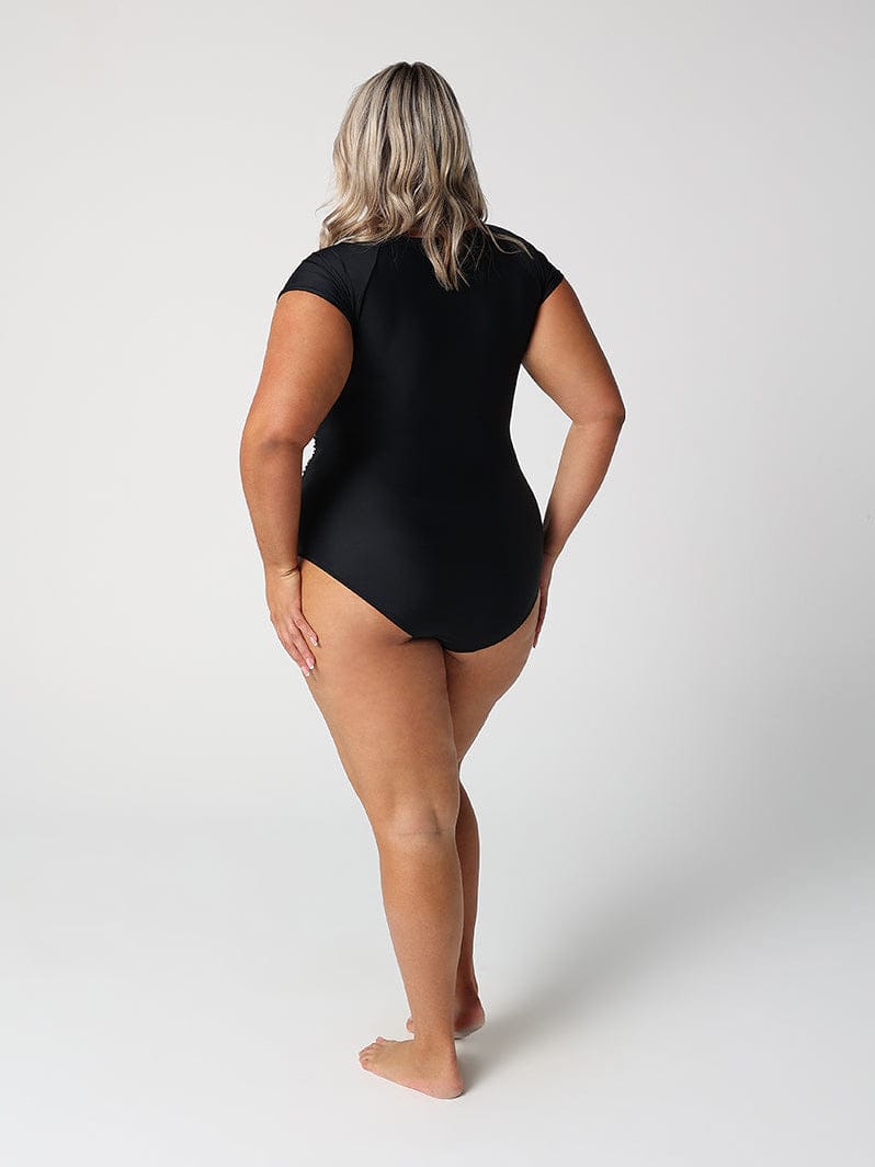 Person wearing a black swimsuit on a white background