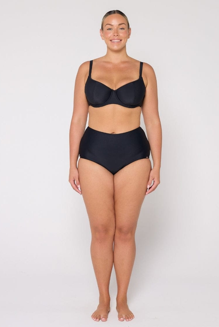 Woman wearing a black bikini set on a white background