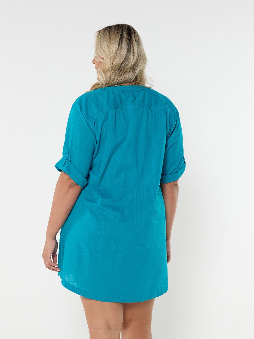 Blonde model showing back of ocean blue women's swimwear cover up dress