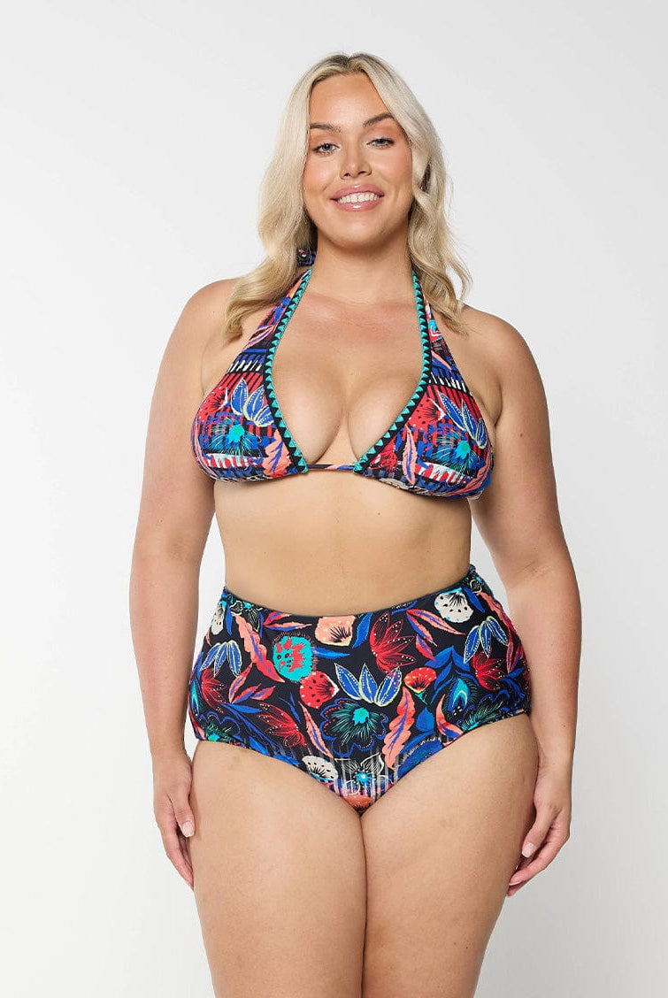 Front of model in studio wearing triangle bikini top in vibrant colourful pattern