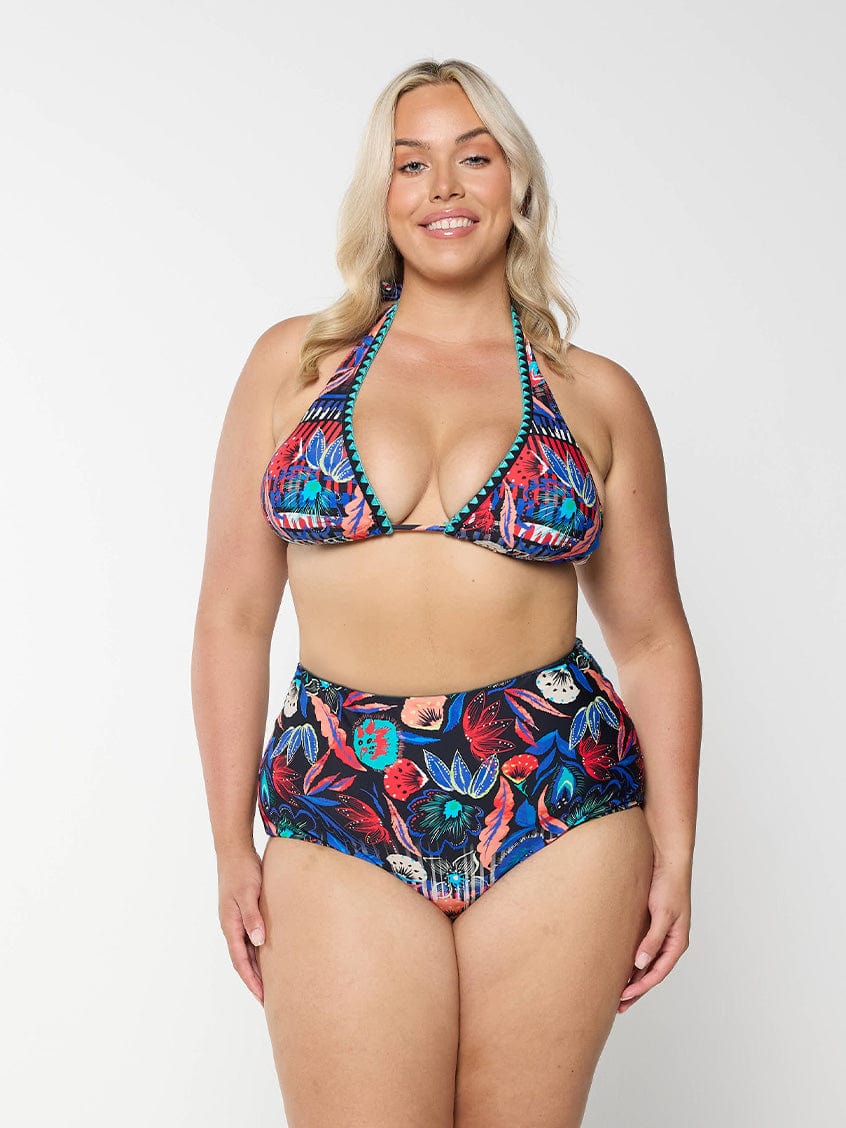 Front of model in studio wearing triangle bikini top in vibrant colourful pattern