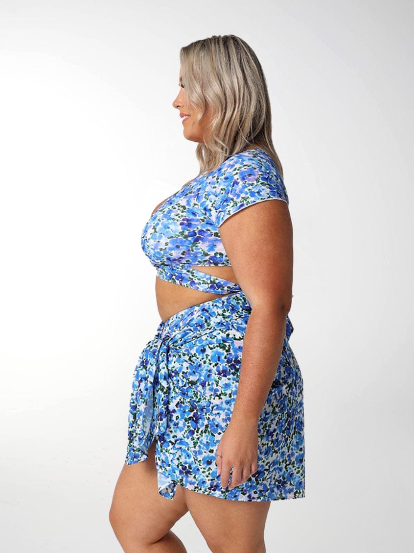 Side profile of model in studio wearing plus size tie sarong skirt