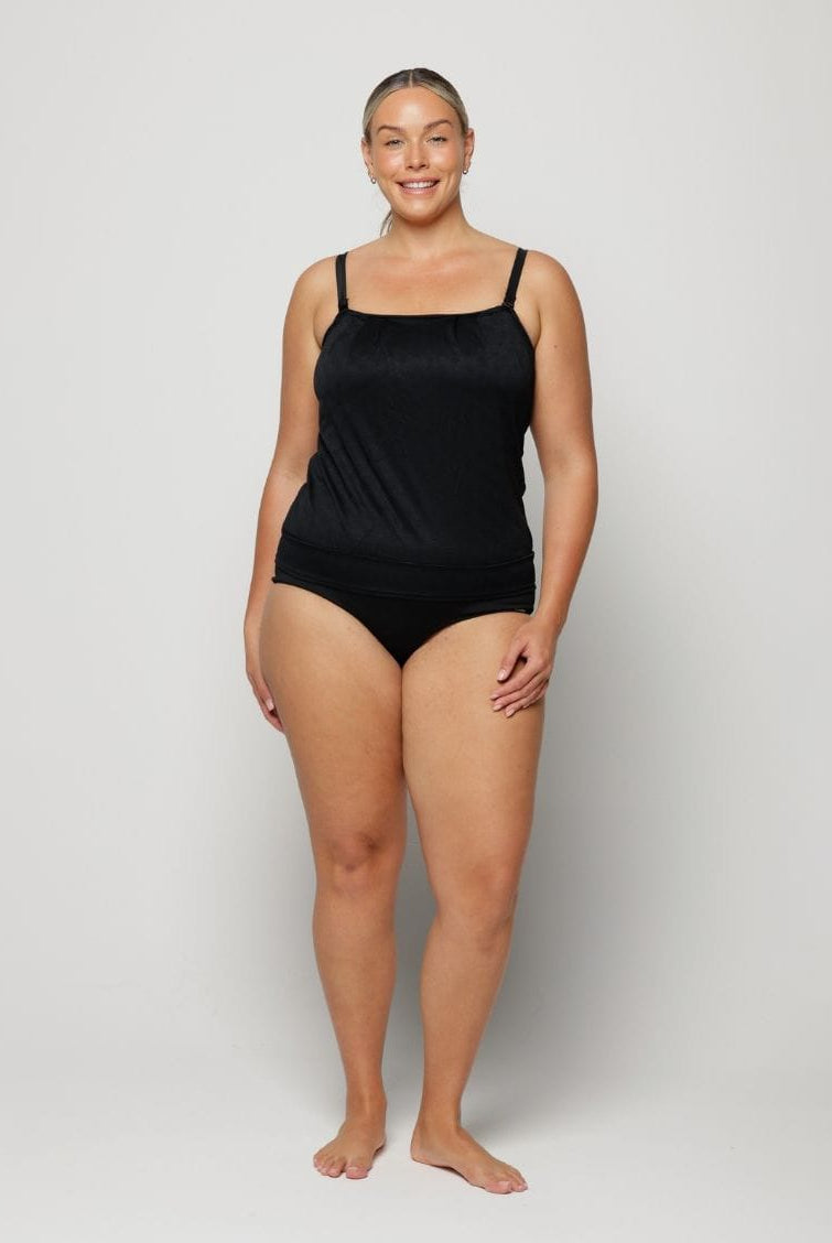 Woman wearing a black swimsuit against a white background
