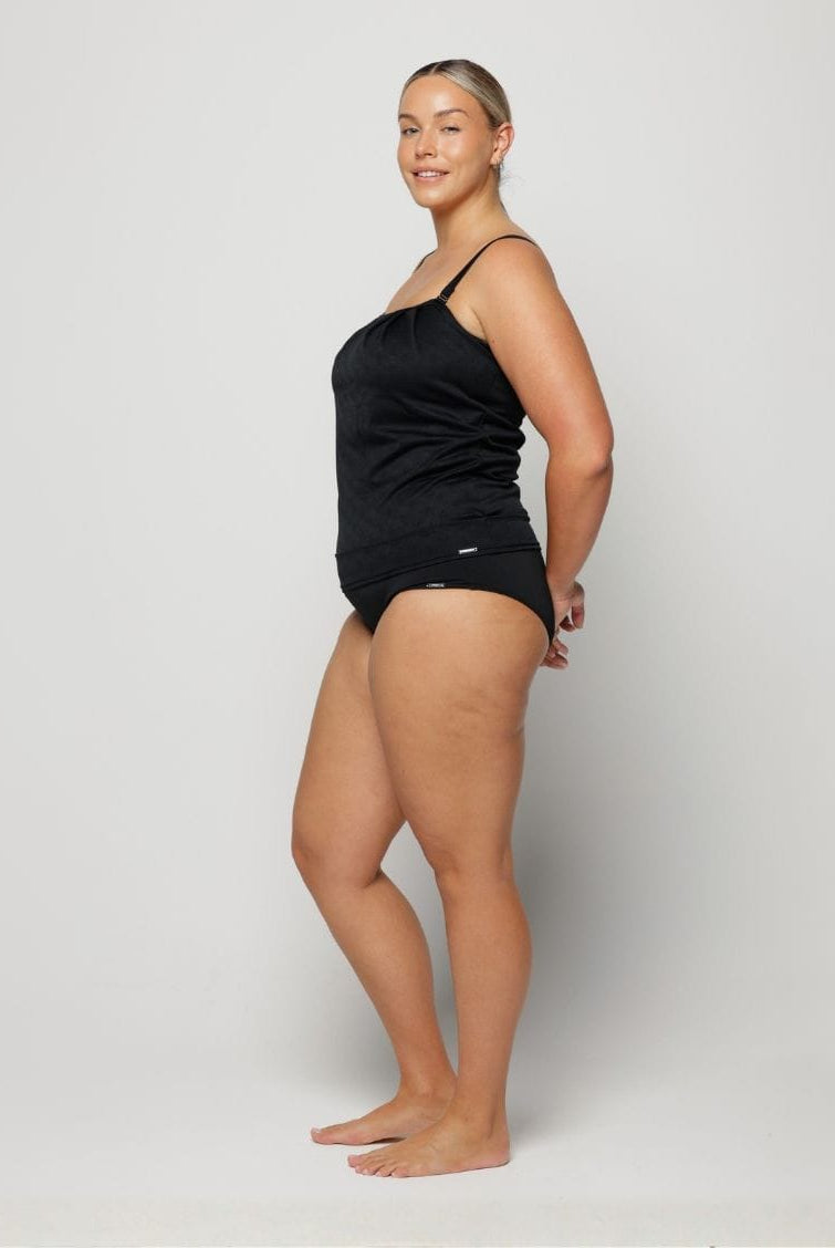 Woman wearing a black swimsuit on a white background