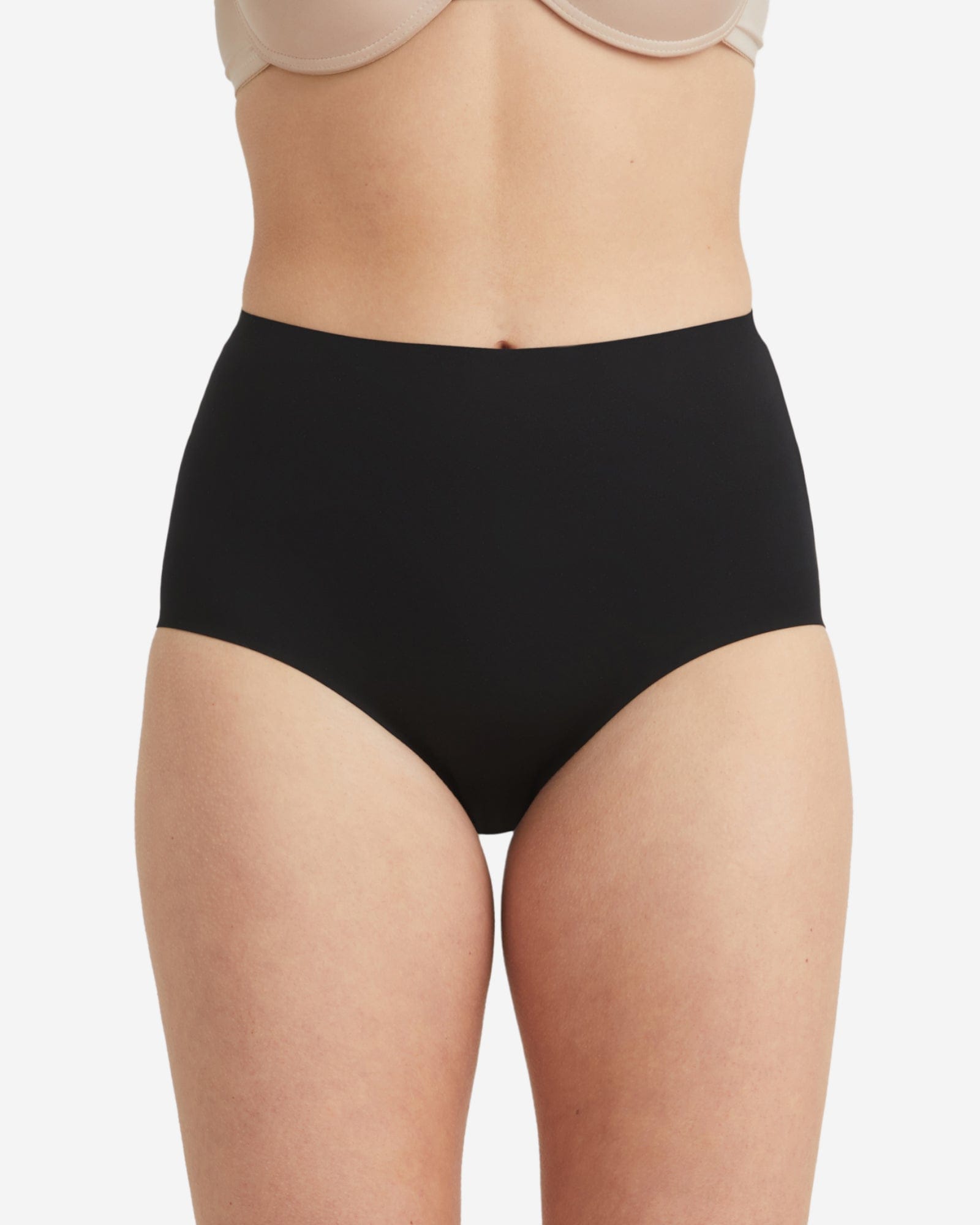 Black high-waisted underwear worn by a person on a white background