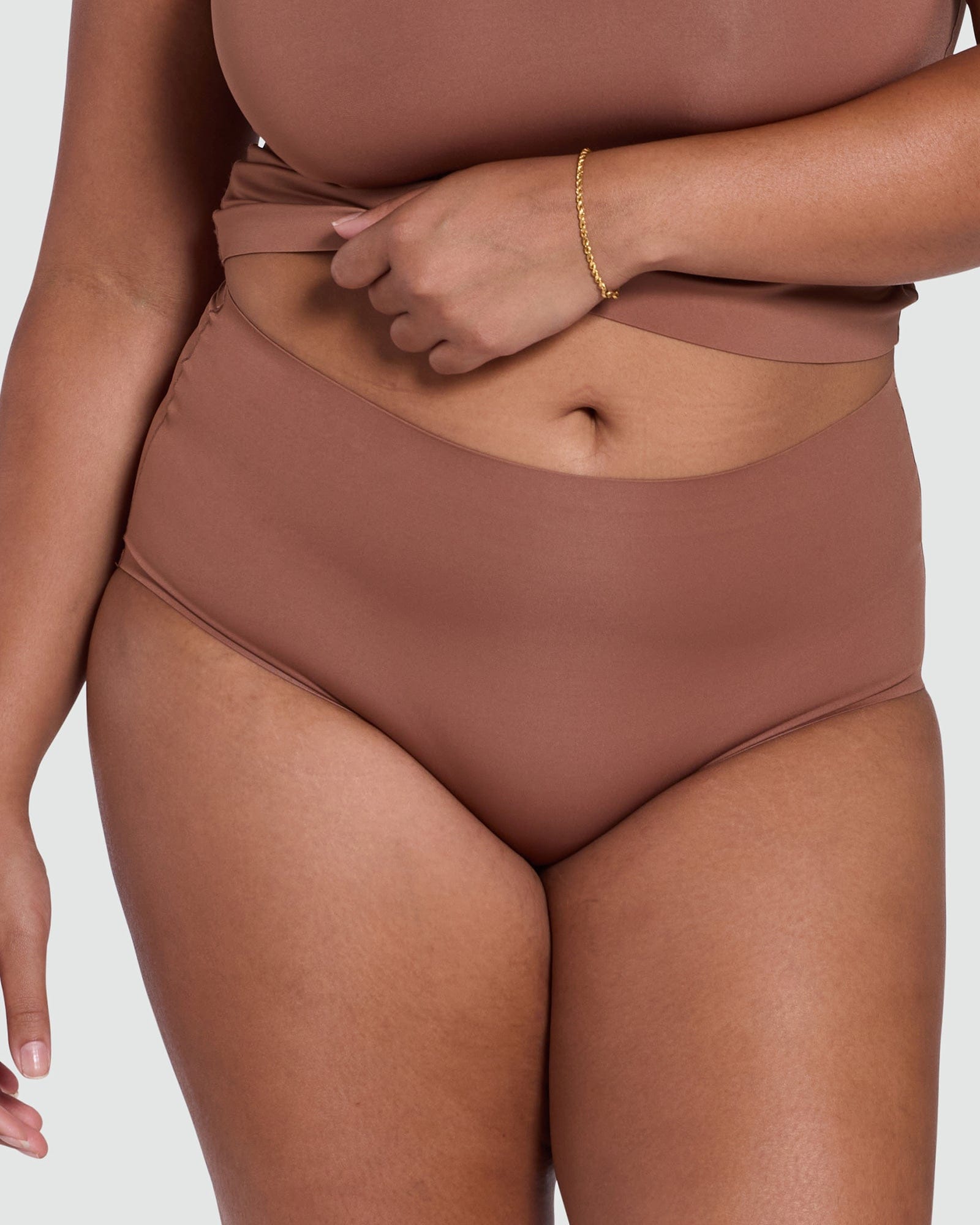 Brown brief worn by a person on a white background