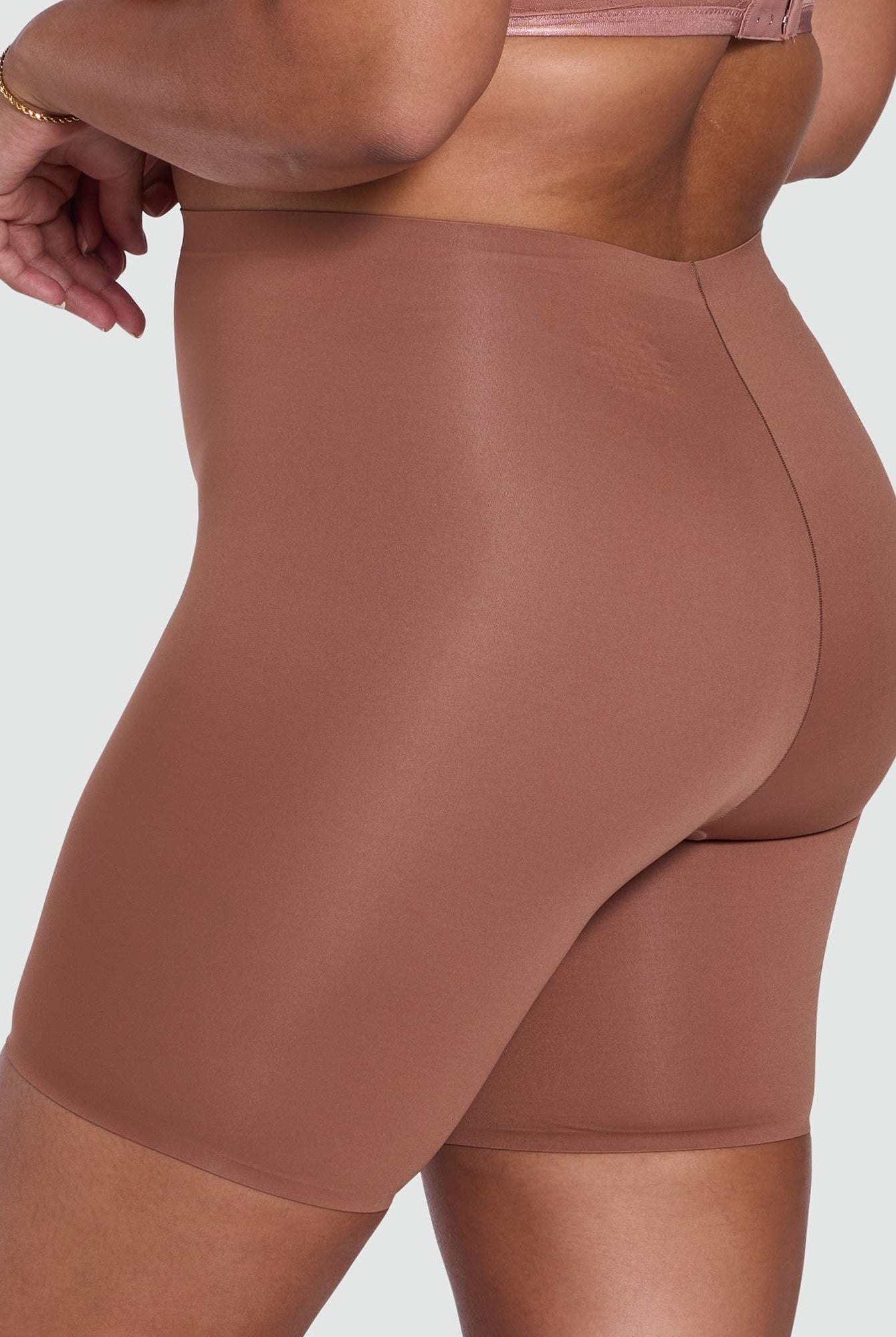 Brown shapewear shorts on a plain background