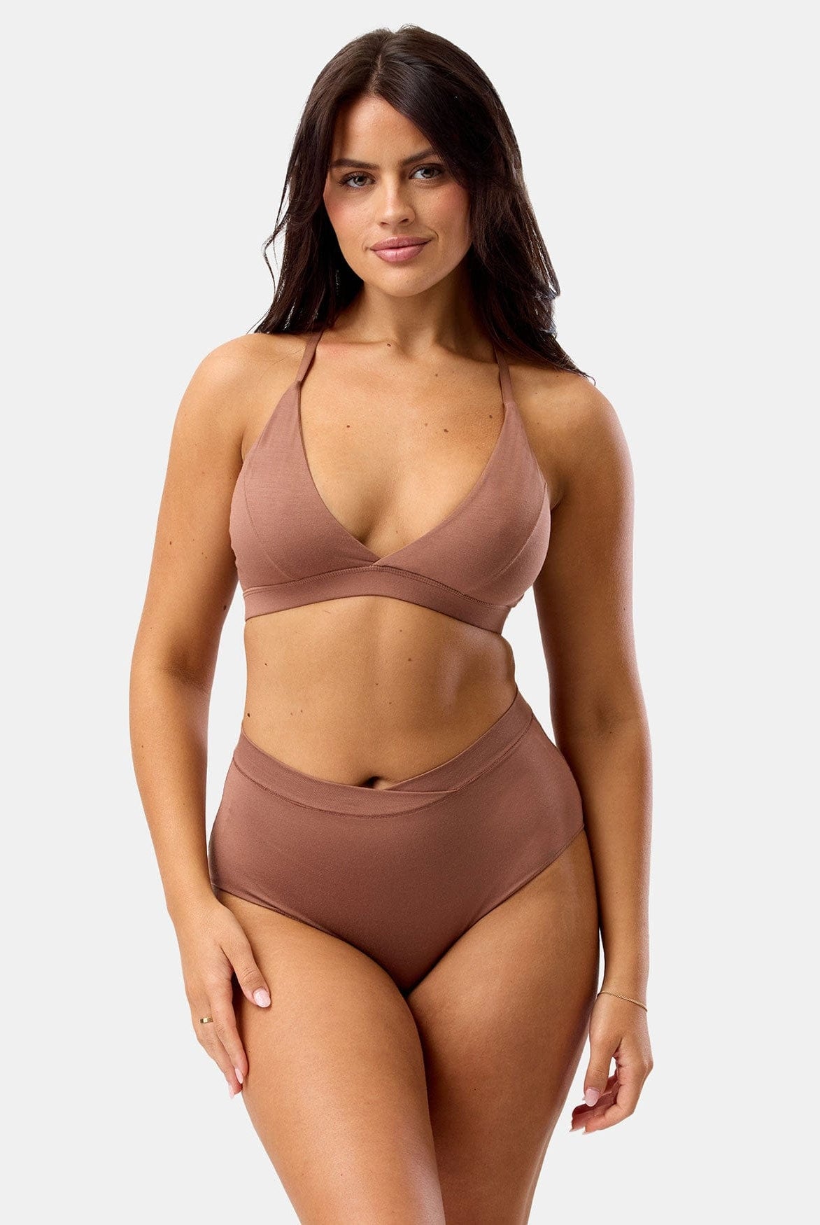 Woman wearing a brown bikini set on a white background