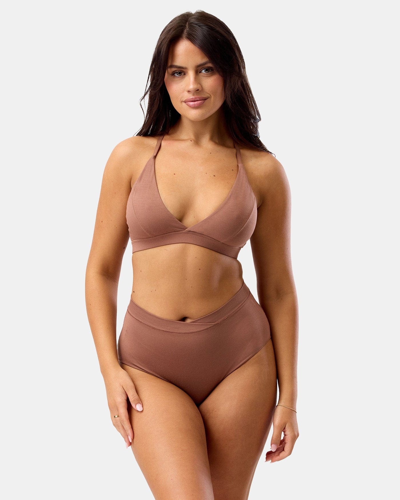 Woman wearing a brown bikini set on a white background