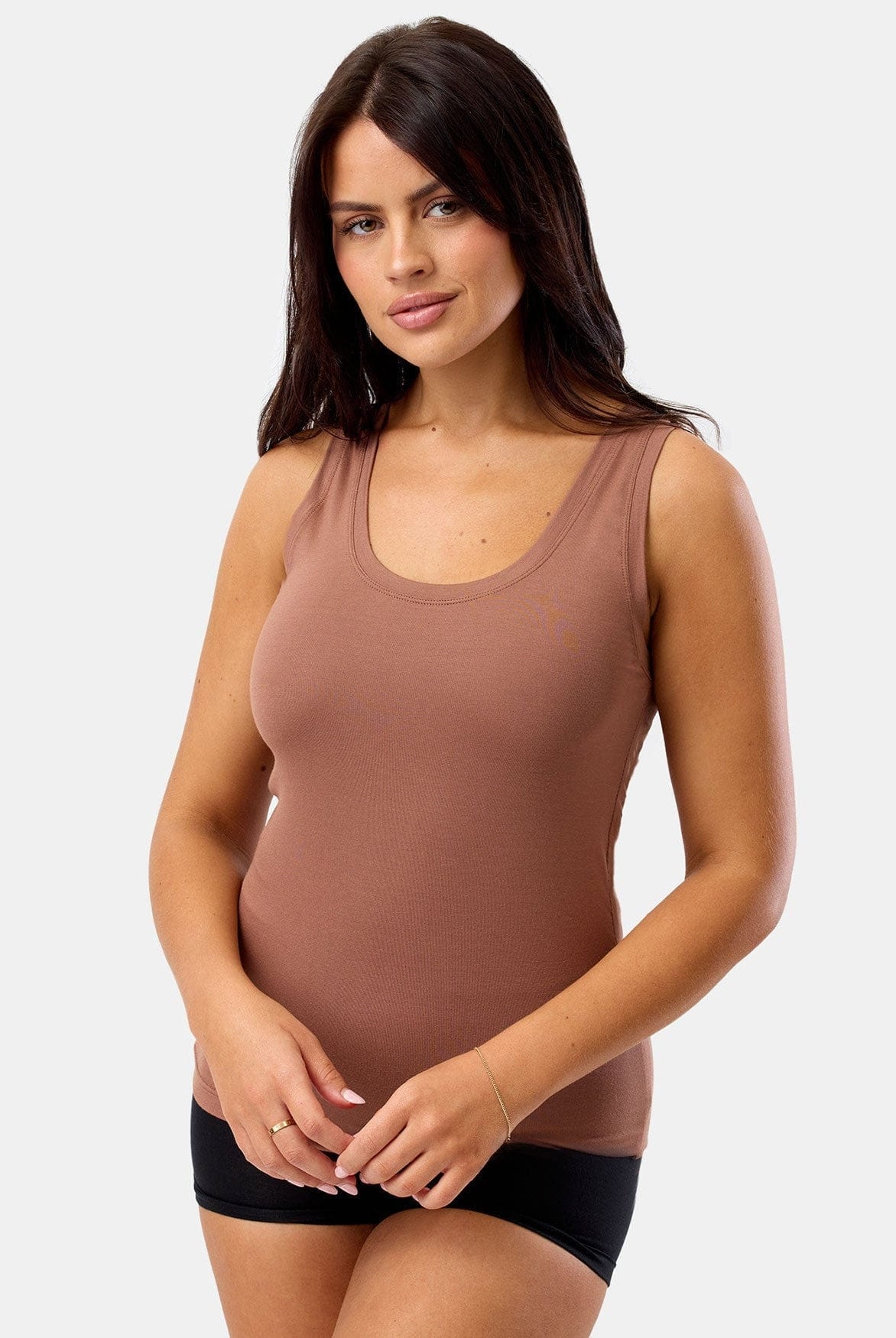 Woman wearing a brown tank top against a white background