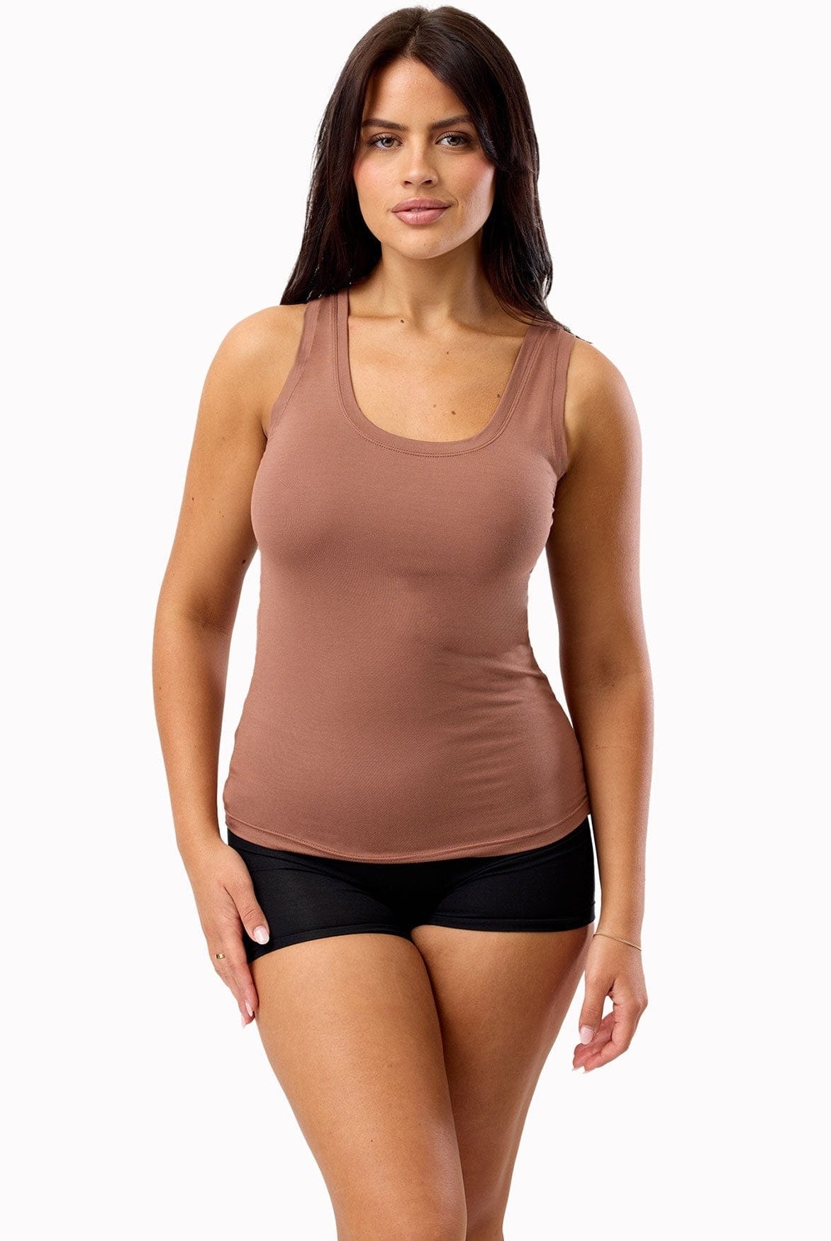 Woman wearing a brown tank top and black shorts on a white background