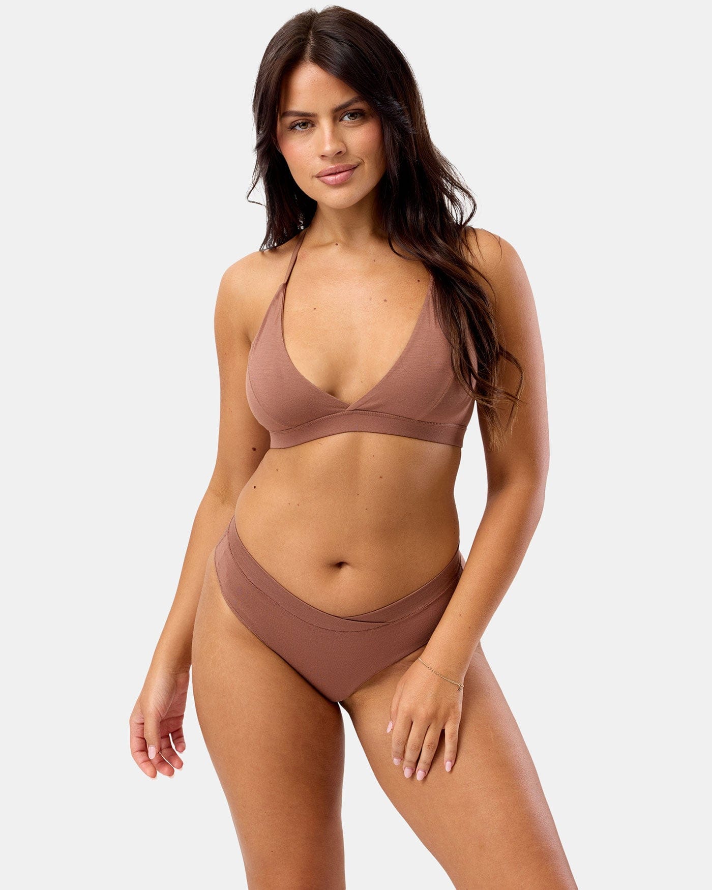 Woman wearing a brown sports bra set on a white background
