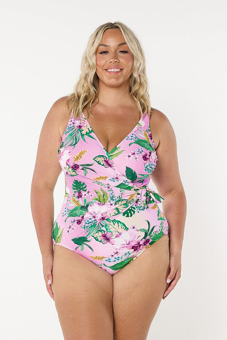 Blonde model in studio wearing pink and green floral one piece