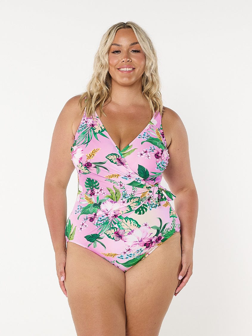 Blonde model in studio wearing pink and green floral one piece