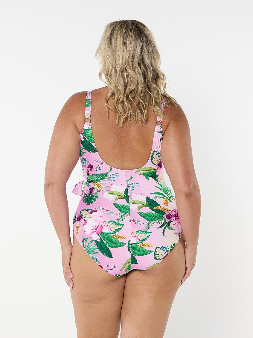 Blonde model in studio wearing plus size one piece with scoop back and adjustable straps