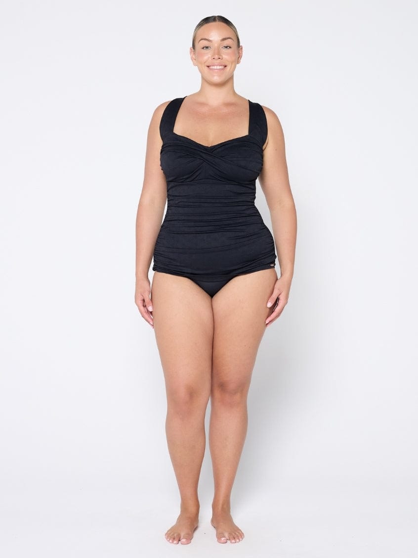 Woman wearing a black swimsuit on a white background