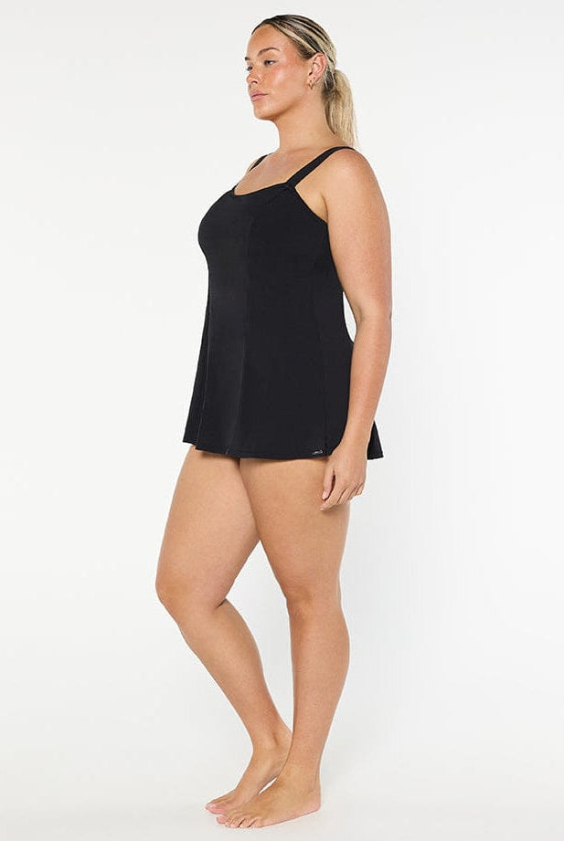 Woman wearing a black slip against a white background