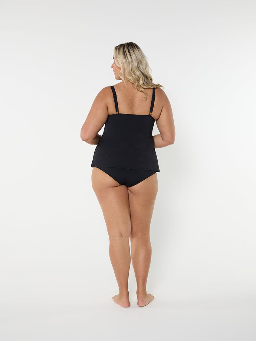 Woman wearing a black swimsuit on a white background