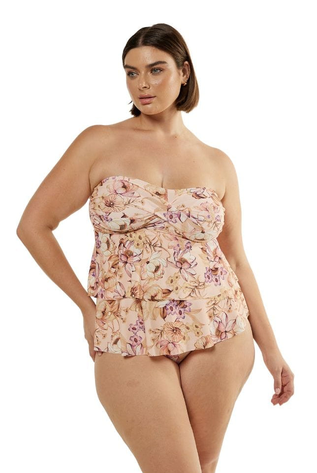 Brunette model wearing pink floral strapless tiered bandeau top