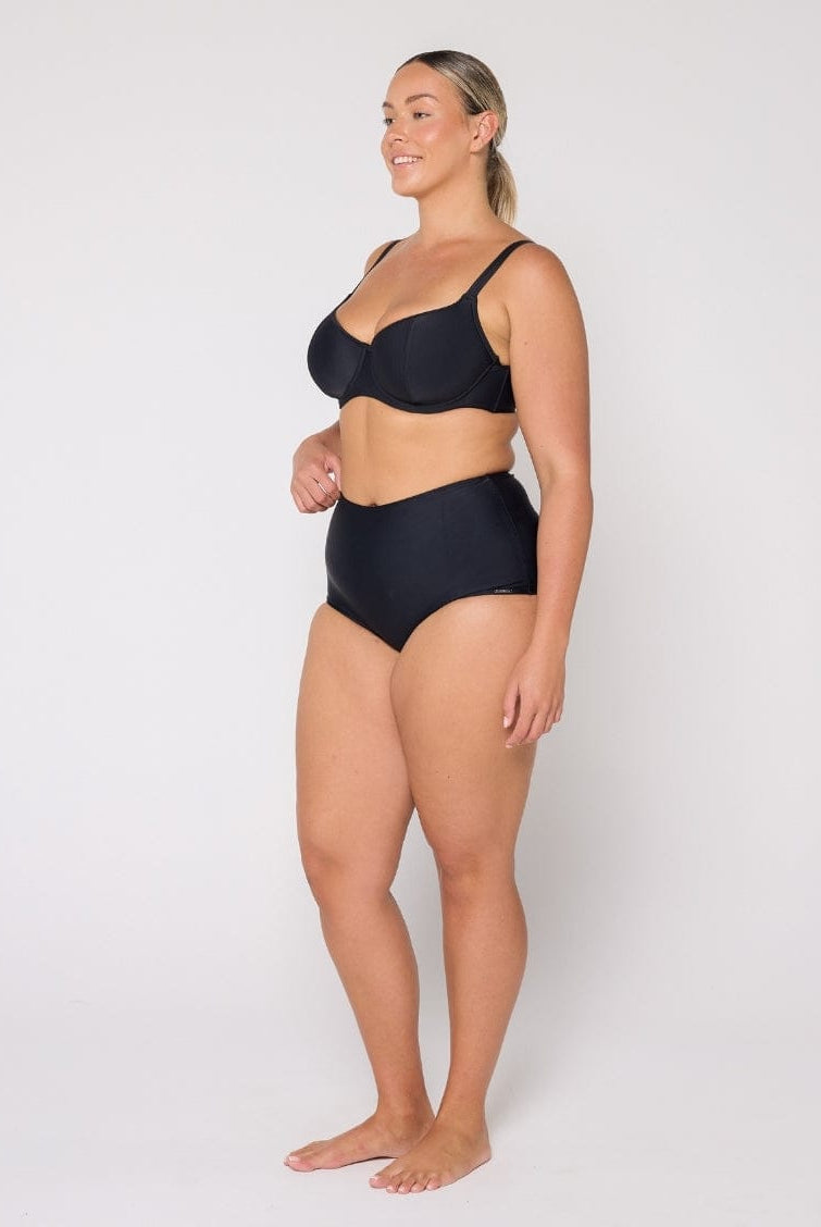 Woman wearing a black bikini on a white background