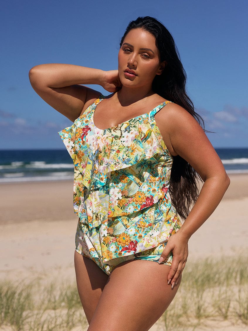 Woman wearing a floral swimsuit on a beach
