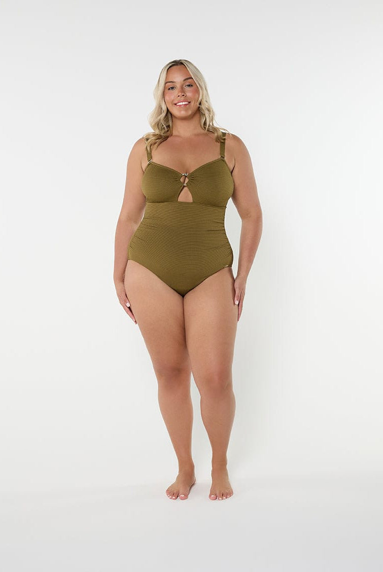 Woman wearing a green swimsuit on a white background