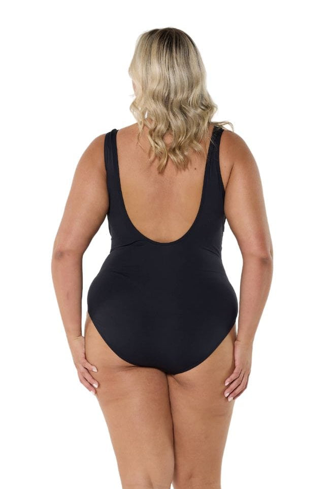 Blonde model showing low back of black and white one piece