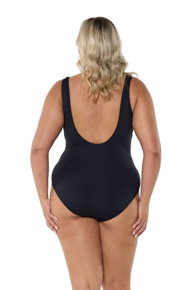 Blonde model showing low back of black and white one piece