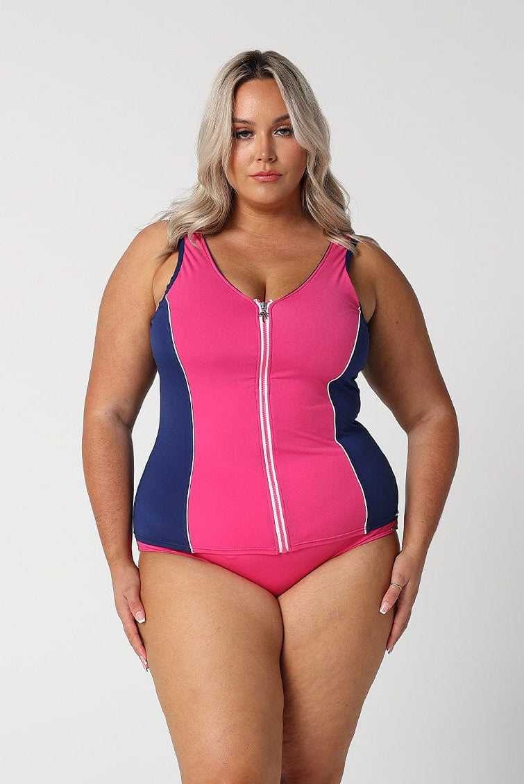 In studio image of blonde model wearing bright pink flattering tankini top with full zip front detail