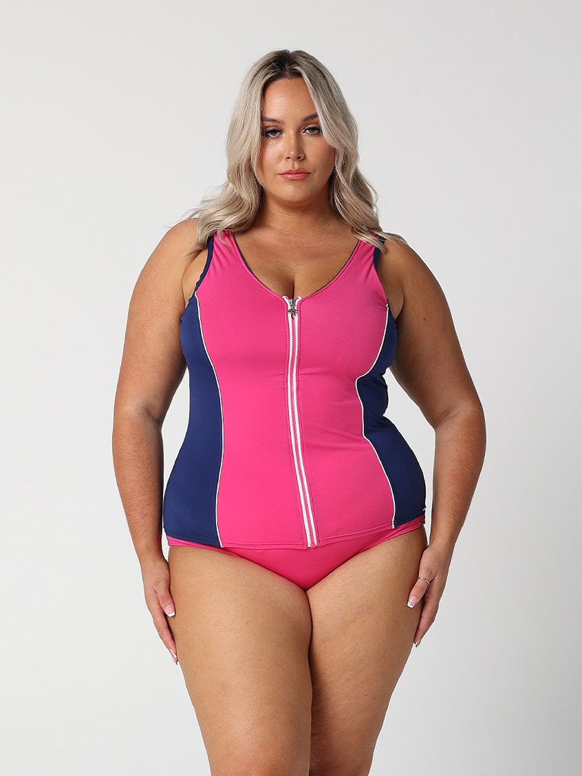 In studio image of blonde model wearing bright pink flattering tankini top with full zip front detail