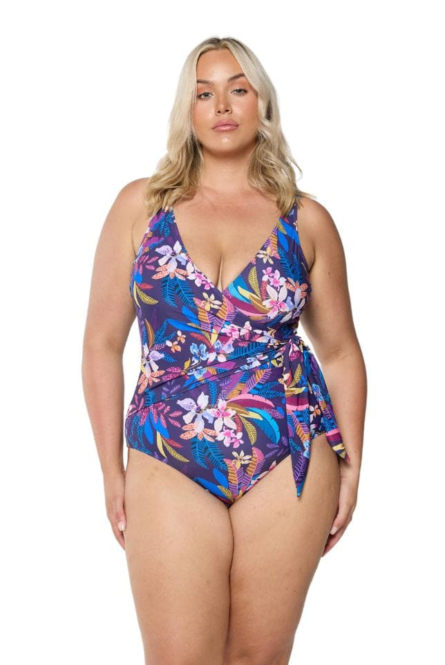 Front of plus size model wearing floral one piece with tie side detail