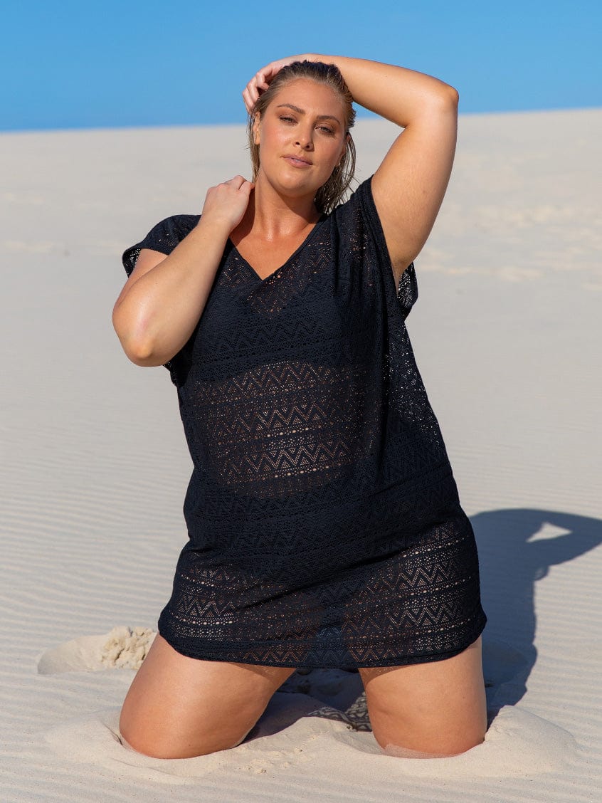 blonde size 18 plus size model wearing black mesh see-through beach cover up at the beach