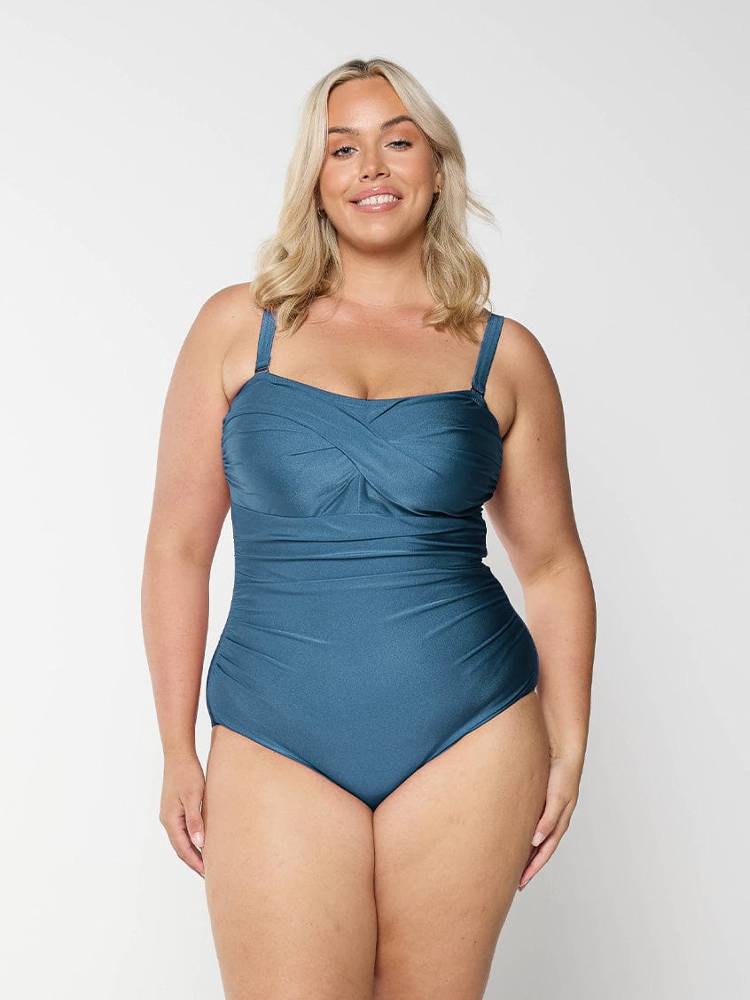 Blonde model in studio wearing grey one piece bandea for curve woman