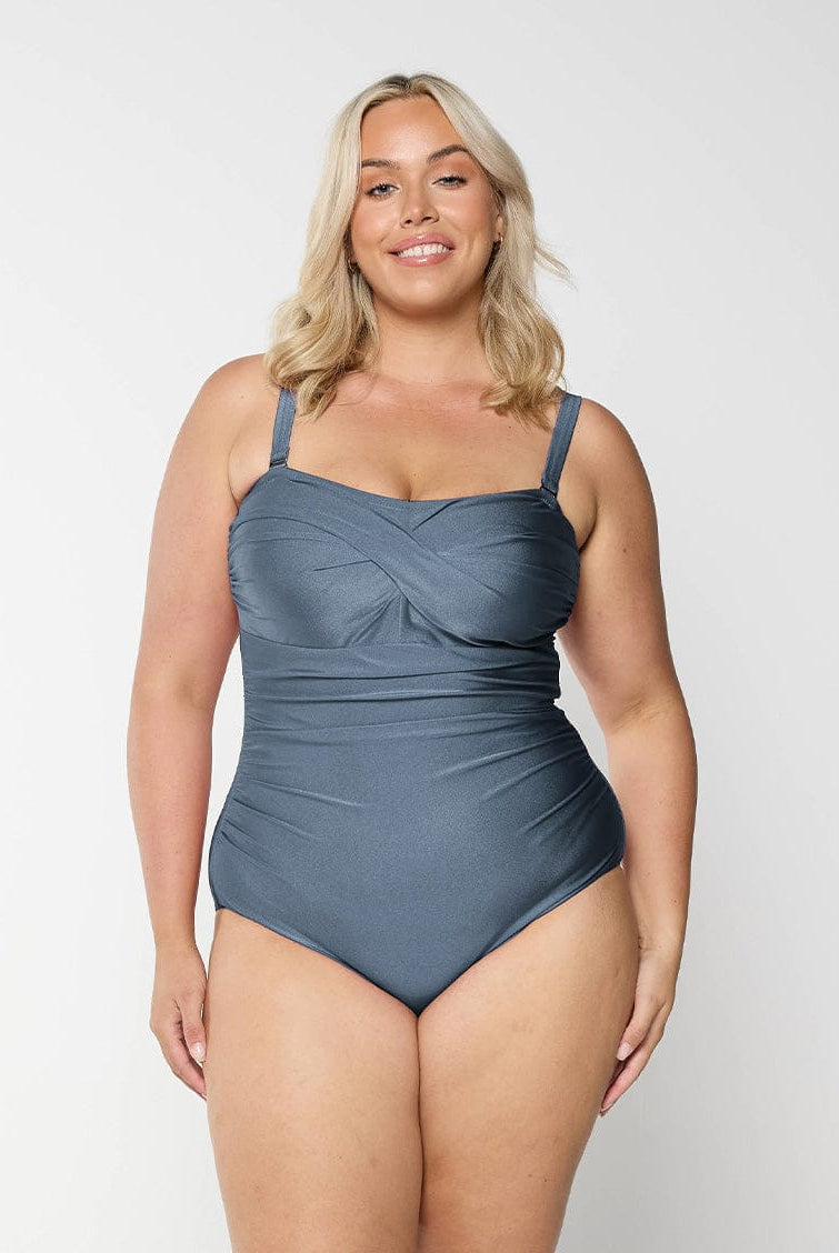 Blonde model in studio wearing grey one piece bandea for curve woman
