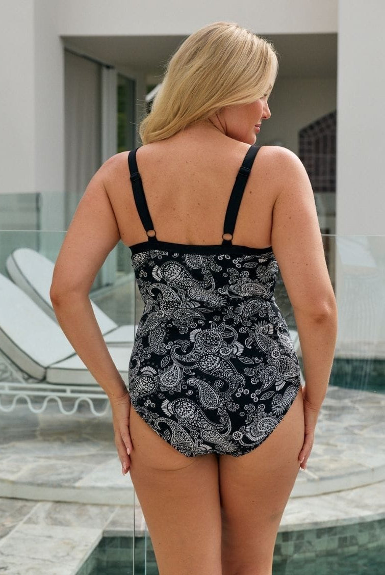 Back of model wearing a one piece with underwire support and adjustable straps in paisley print